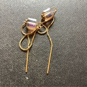 Gold tone threader earrings with clear bead accent.